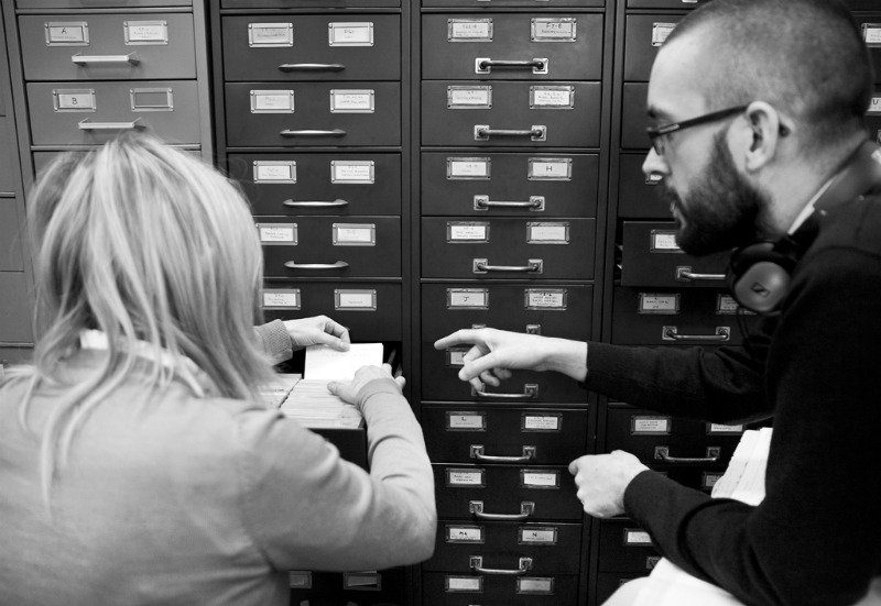 Aileen Campbell and Drew Wright looking through the card catalogue in the Scottish Archives.