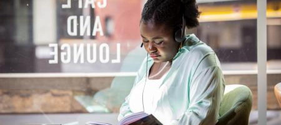 Student with book in cafe