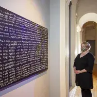 Larry Achiampong. Detention.  Blackboard, chalk. Pictured – Melissa MacRobert, Exhibitions Manager at Talbot Rice Gallery