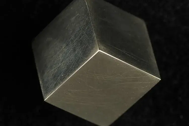 One Pound Coin, 2017 by Lara Hirst - Exploring material and perceptions of value, Hirst transforms a single pound coin by recasting it into a perfect cube