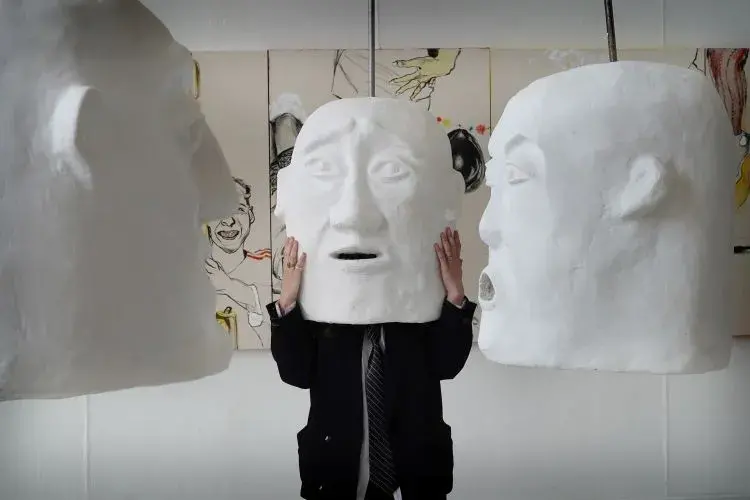ECA student Elena Gadd wears a large white 'head' sculpture created as part her final showcase 'The Funeral'.