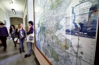 Students standing next to map of Scotland