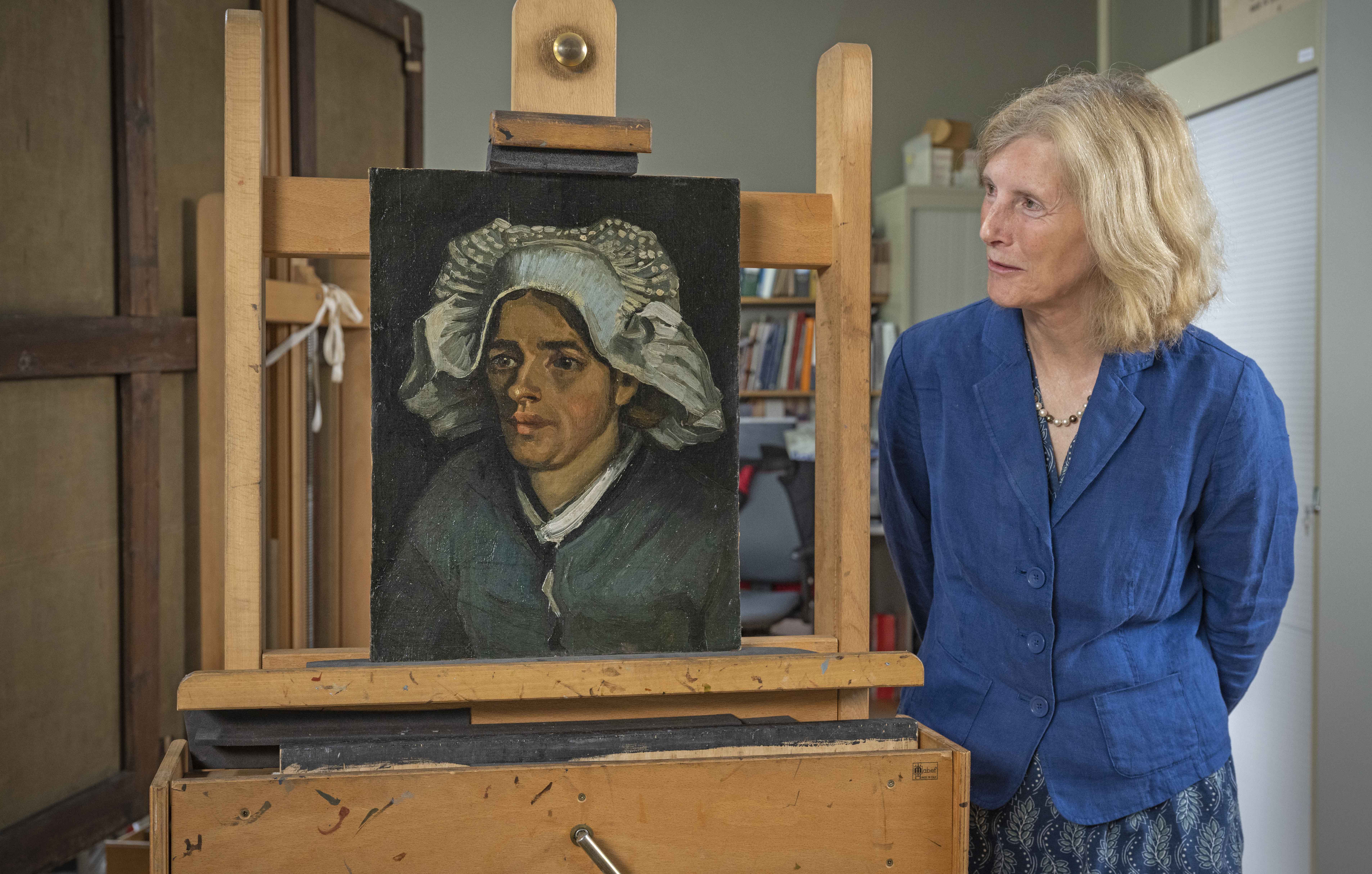 Researcher looking at painting