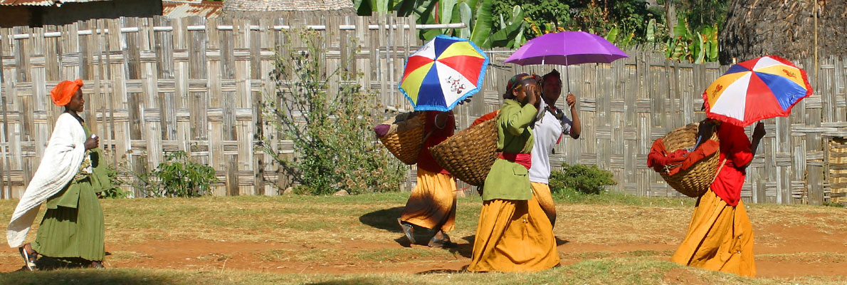 Photo of women using umbrellas to shade from the sun in an Ethopian village