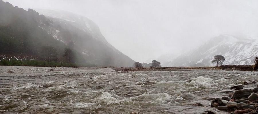 raging river below a mountain